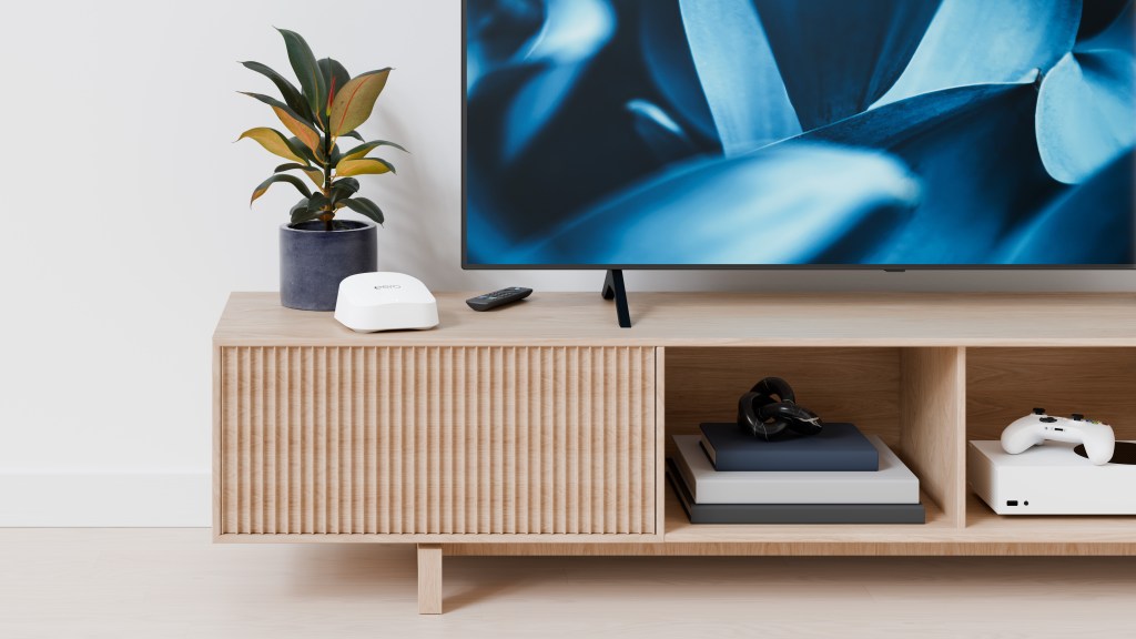 White eero 7 router on a wood television console
